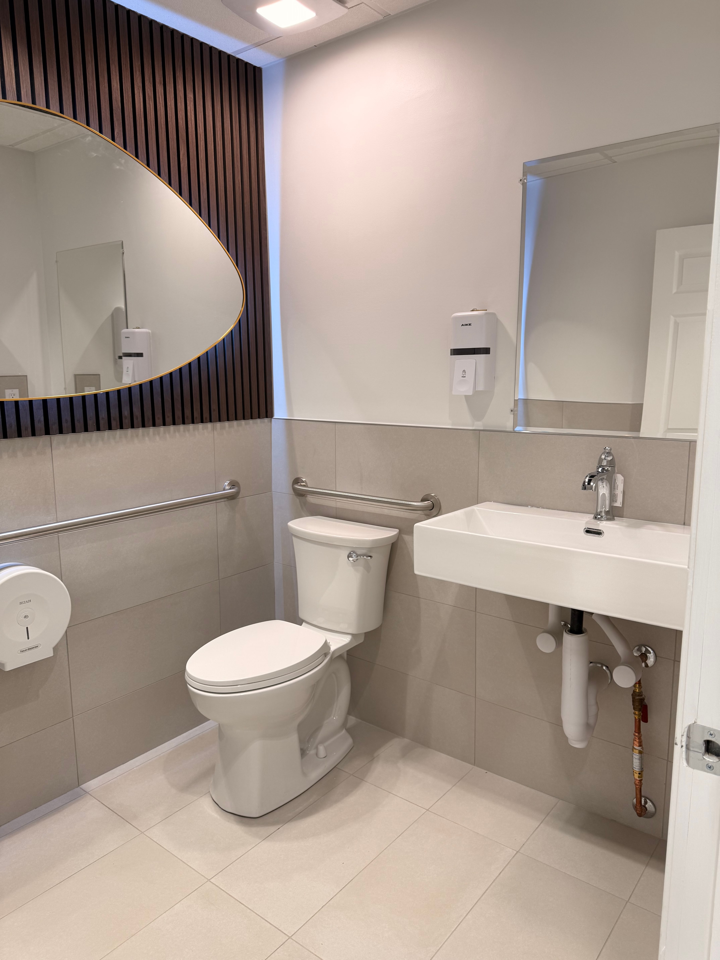 A bathroom with two sinks and two mirrors