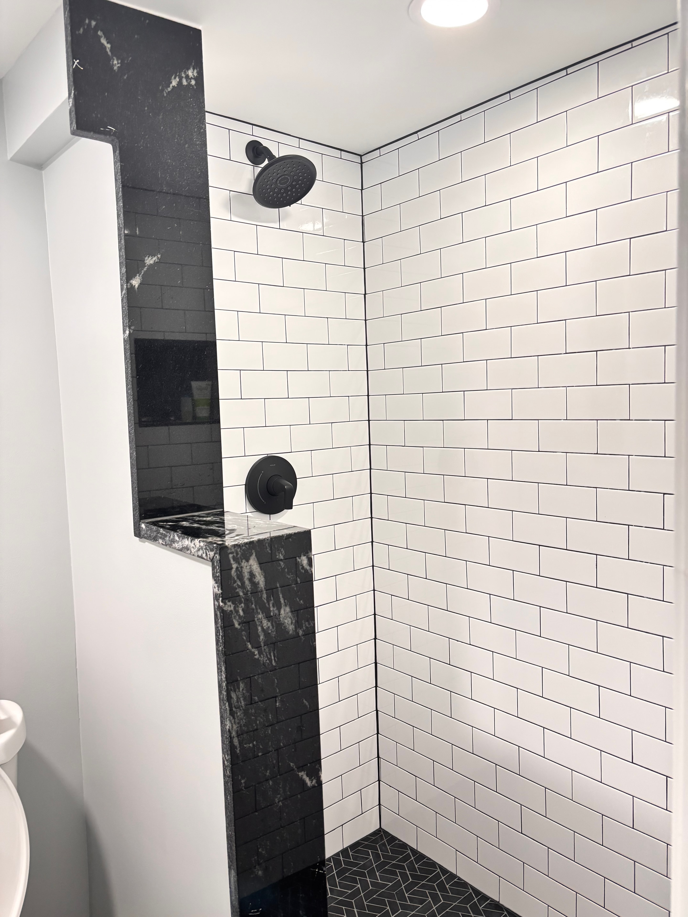 A bathroom with a walk-in shower and a bathtub